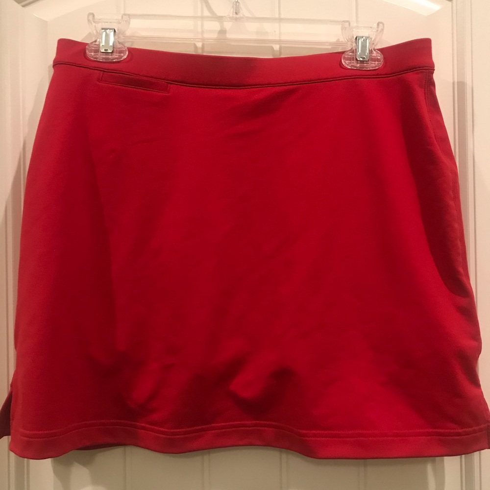 True red tennis/golf skirt. Shorts underneath.